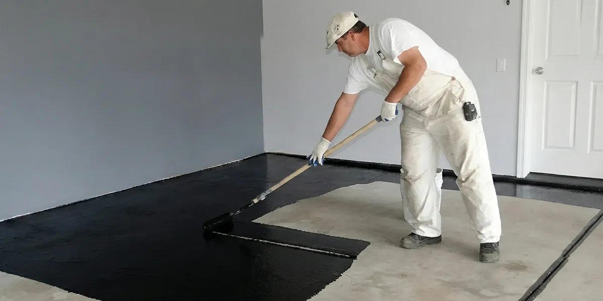 basement waterproofing professional applying waterproof coating to protect a basement floor in Reno, NV