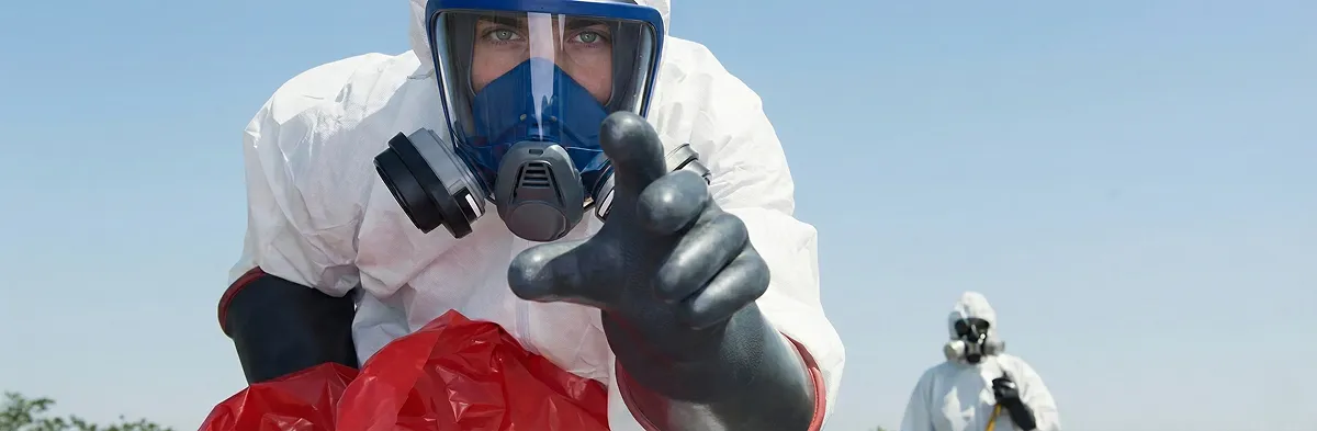 sewage clean up technician wearing protective gear handling biohazard materials in Reno, NV